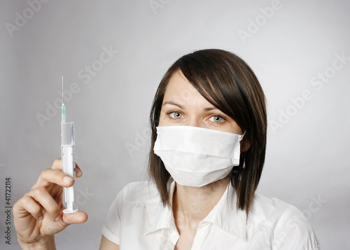 Photo: Doctor in mask with syring Doctor in mask with syring