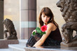 Sad young woman with a rose