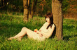 Beautiful young girl sleeping under the tree. Sunset time Beautiful young girl sleeping under the tree. Sunset time