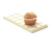 bar of white chocolate and muffin isolated on white