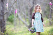 Photo: Little girl with floral bouquet in woodland Little girl with floral bouquet in woodland