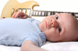 Baby boy laying with guitar