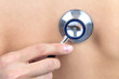 Doctor hand auscultating patient by stethoscope