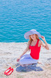 The girl on the rocks against the sea