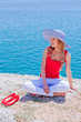 The girl on the rocks against the sea