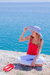 The girl on the rocks against the sea