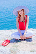 The girl on the rocks against the sea