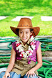 Asian school girl sitting smiling in the park