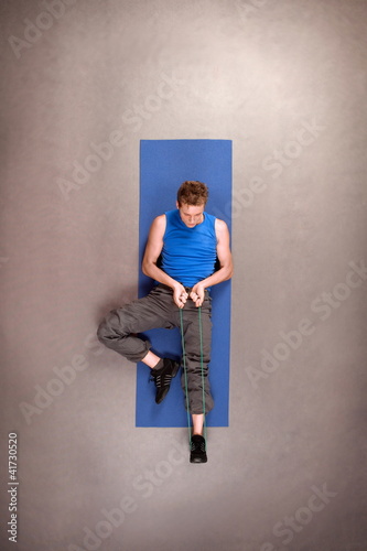 Photo: Overhead view of exercising fit man in studio Overhead view of exercising fit man in studio