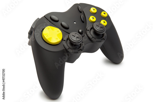 Photo: Black game controller with yellow buttons. Black game controller with yellow buttons.