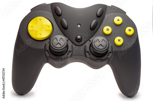 Photo: Black game controller with yellow buttons. Black game controller with yellow buttons.