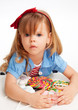 Greedy  girl with pile of sweets