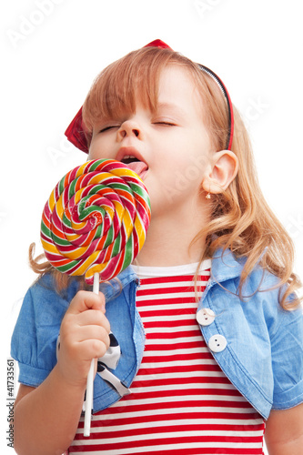 Photo: Little girl licking big lollipop Little girl licking big lollipop