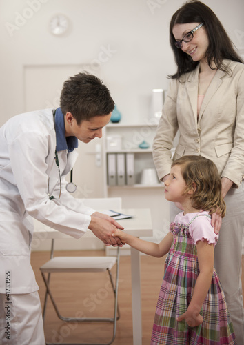 Photo: Pediatrician shaking hand with girl child patient Pediatrician shaking hand with girl child patient