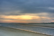 Sunrise above a beach and a creek at ebb tide Sunrise above a beach and a creek at ebb tide