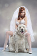 Young woman wearing wedding lingerie with dog