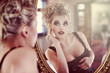 Foto: Beautiful sexy young woman near a mirror Beautiful sexy young woman near a mirror