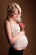 Beautiful pregnant blond woman , a studio portrait.