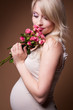 Beautiful pregnant blond woman , a studio portrait.