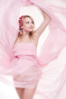 beautiful young pregnant woman wrapped into pink fabric
