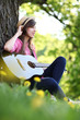 Young woman playing guitar in park