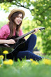 Woman playing guitar in park