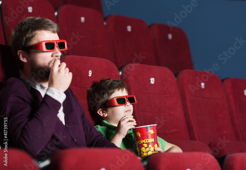 Photo: A boy with father at the cinema A boy with father at the cinema