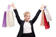 Foto: Young business woman in a black suit holding shopping bags Young business woman in a black suit holding shopping bags