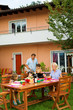 Family having a barbecue in the garden, eating
