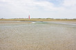 Beach with creek, dunes and lighthouse Beach with creek, dunes and lighthouse