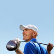 Smiling golfer holding golf club over shoulder