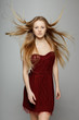 Fashion model posing with hair fluttering in the wind