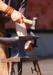 The smith forges a horseshoe