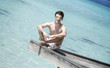 Photo: Man sitting on a jetty (Maldives) Man sitting on a jetty (Maldives)