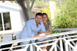 Smiling couple standing in private home gazebo