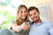 Couple in sofa watching tv