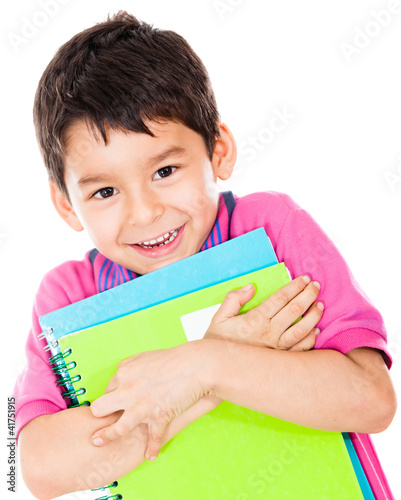 Photo: Boy carrying notebooks Boy carrying notebooks