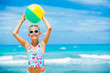 Girl with ball on the beach
