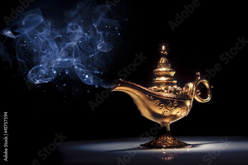 Photo: Magic Aladdin's Genie lamp on black with smoke Magic Aladdin's Genie lamp on black with smoke