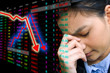 Business woman serious a falling graph of stock market