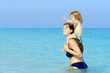 Happy child with her mother on the beach
