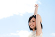 Beautiful young woman outdoors over blue sky
