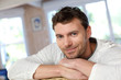 Portrait of young smiling man relaxing in sofa Portrait of young smiling man relaxing in sofa