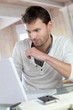 Man working at home on laptop computer Man working at home on laptop computer