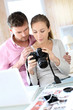 Couple at home looking at pictures on camera and laptop Couple at home looking at pictures on camera and laptop