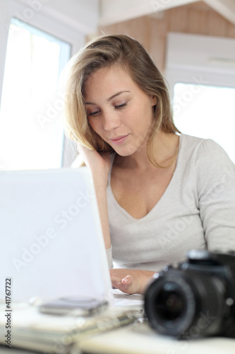 Photo: Woman working at home on laptop computer Woman working at home on laptop computer