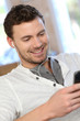 Portrait of young man listening to music with smartphone