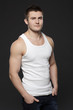 Young handsome muscular man in white t-shirt posing