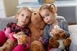 Photo: Little girls on sofa with teddy bear Little girls on sofa with teddy bear