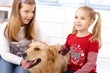 Little girls with dog at home